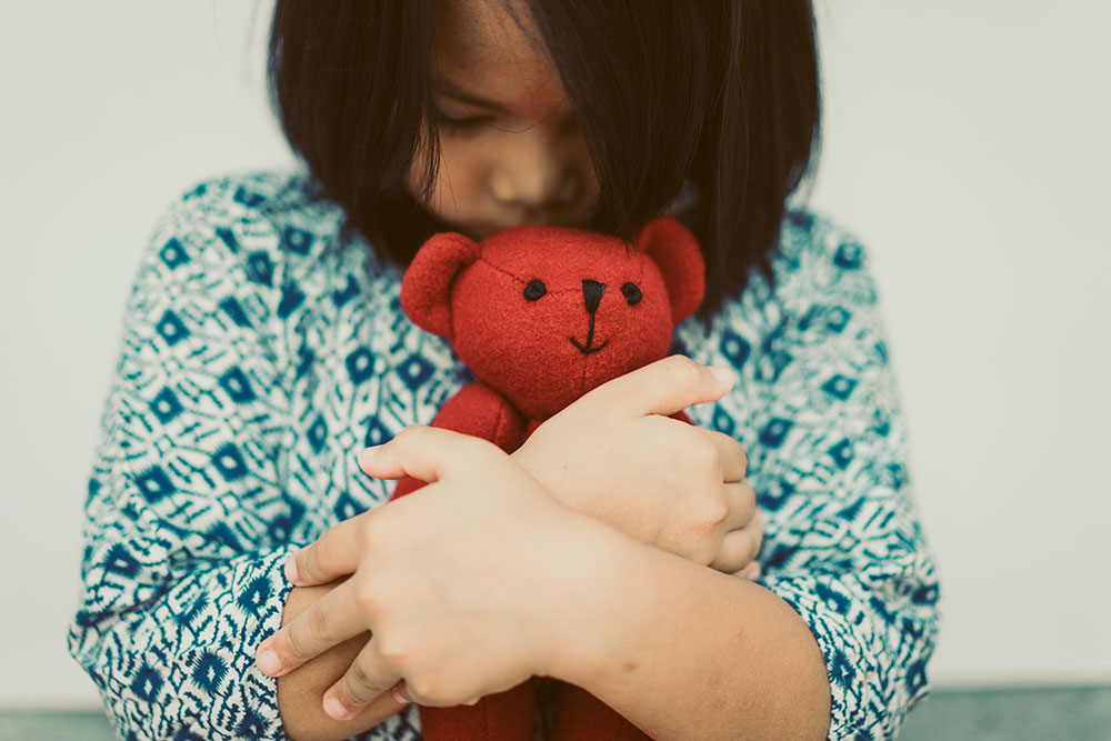 Child sexual abuse child holding stuffed bear
