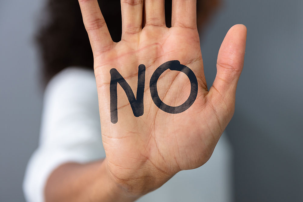survivor say no written on hand