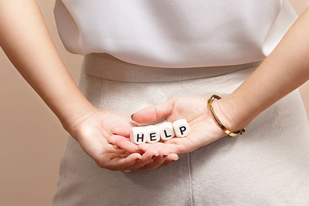 woman holding blocks that spell out help in her hands